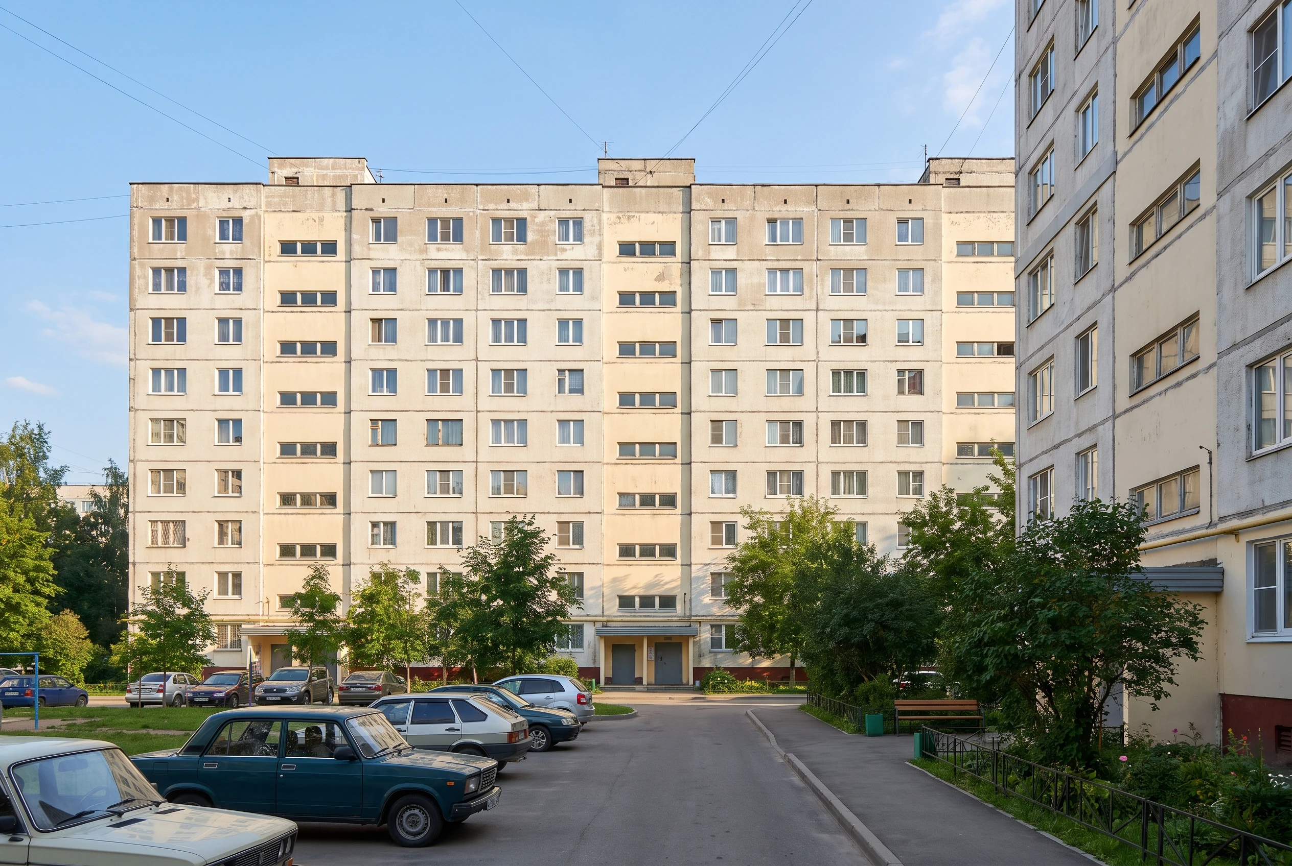 Панельная многоэтажка до ремонта — обычный устаревший фасад, аккуратный двор